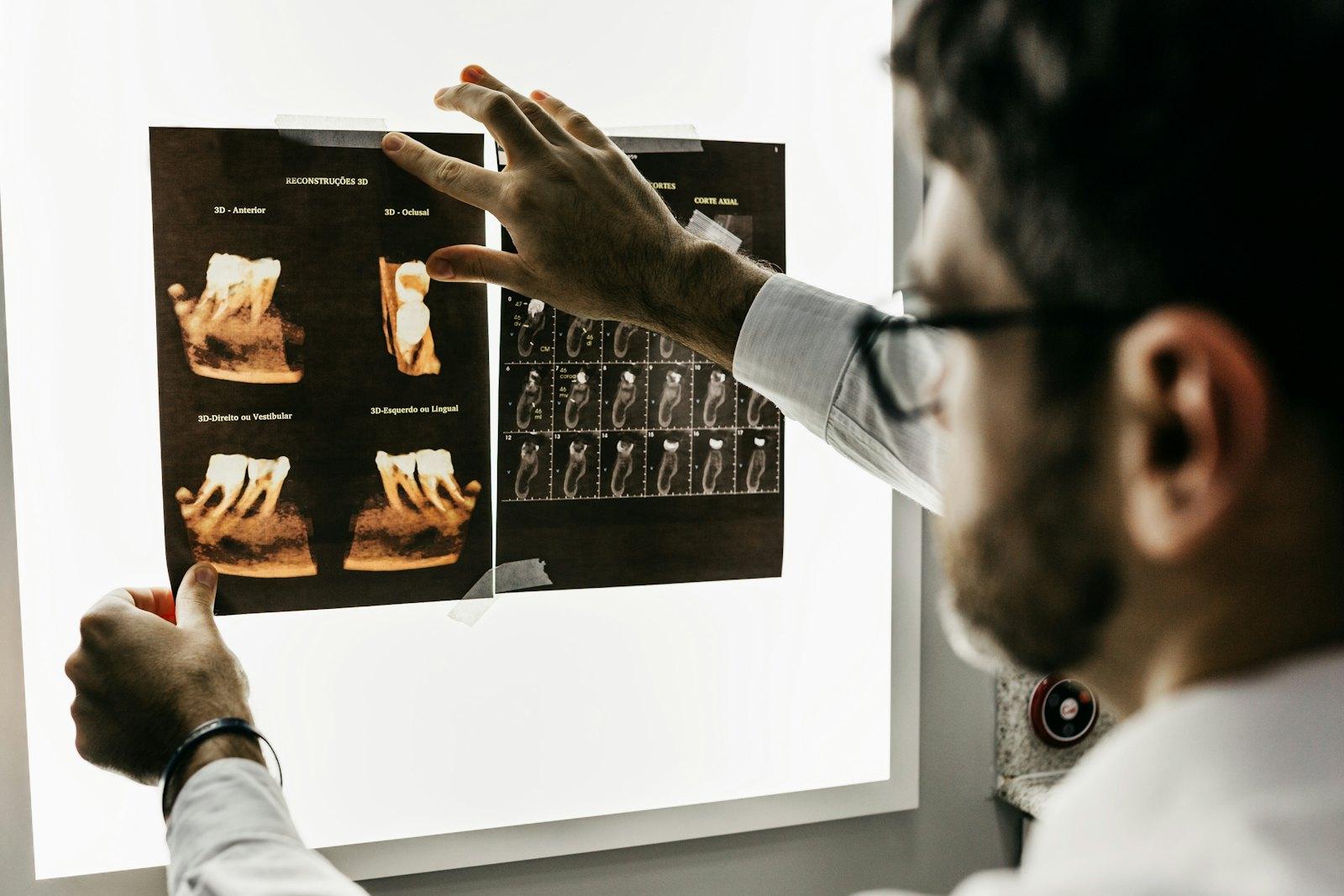 Dr. Omar Nasser reviewing a patient's X-rays