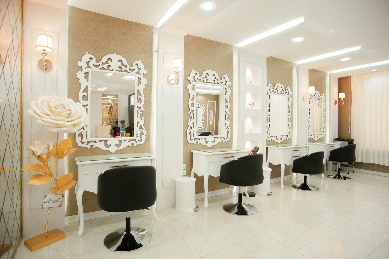 Bright salon interior with styling chairs and arched mirrors