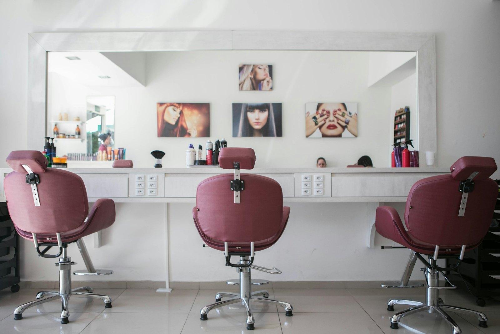 Row of styling chairs facing a long mirror